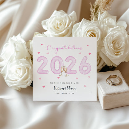 Personalised 2026 Wedding Card - Custom Couple's Surname & Wedding Date – Pink 2026 with Champagne Toast Design - Wedding Congratulations Card for Newlywed couples, Him or Her - Pink Envelope Included