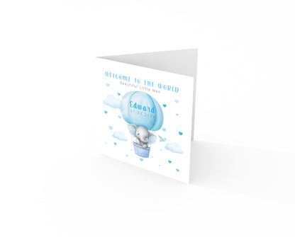 Personalised New Baby Boy Card Congratulations for Newborn Son, Grandson, Nephew, Welcome To The World Card - Elephant in a Hot Air Balloon Design with Custom Name and Date - Blue Envelope Included