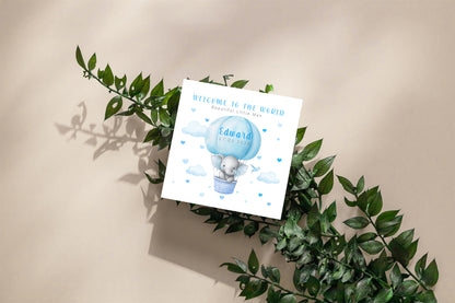 Personalised New Baby Boy Card Congratulations for Newborn Son, Grandson, Nephew, Welcome To The World Card - Elephant in a Hot Air Balloon Design with Custom Name and Date - Blue Envelope Included